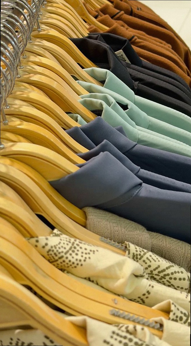 A stylish assortment of clothing on hangers showcasing various colors and materials.